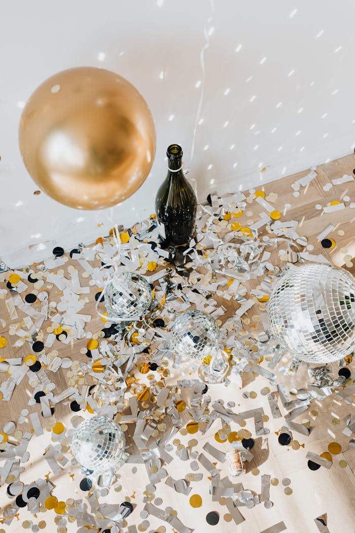 Celebratory scene with confetti, disco balls, and a bottle, perfect for events and parties.