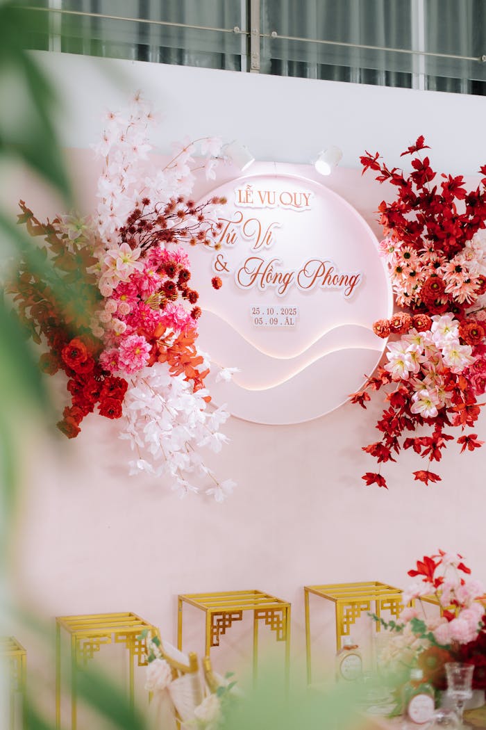 Sophisticated event decor featuring vibrant red and pink floral designs at a wedding ceremony.